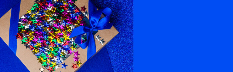 craft gift box with satin blue bow and colorful stars