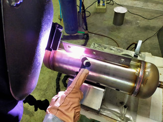 Metal workers use manual labor. Skilled welder. Factory workers making OT. Welder is welding the...