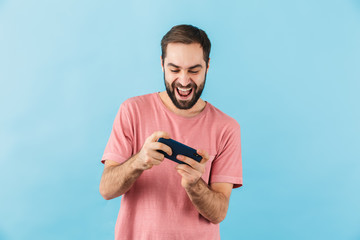 Happy man isolated over blue wall background