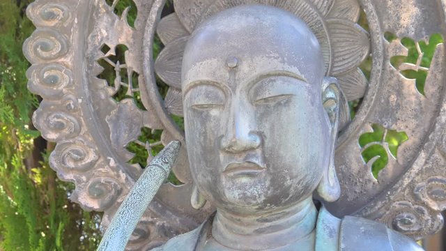 A white budda statue outside the temple in Tokyo Japan