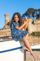Beautiful girl sitting on a fish boat