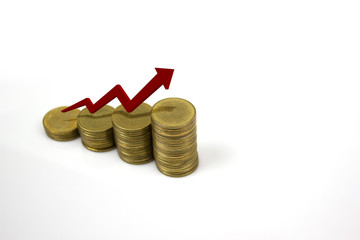 Growing stack of coins with rising red arrow on white background with space on right. Business and financial concept.