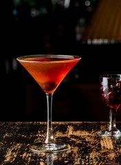 Manhattan, classic American cocktail, made with rye whiskey bitters shaken and strained into a martini glass and garnished with a bourbon soaked cherry and lemon peel.