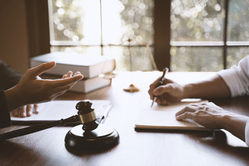 lawyer consulting with client discussing about lawsuit.