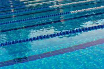 Empty outdoor swimming pool with lanes. Summer holidays or sport concept