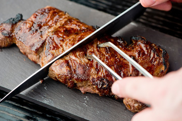Steak. Grade A, grass fed angus beef. Traditional classic New York steakhouse menu favorite. T-bone steak, bone in, cooked to medium to rare and sliced. 