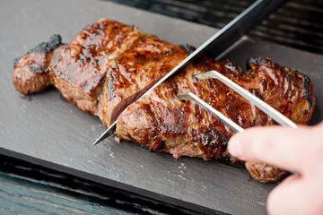 Steak. Grade A, grass fed angus beef. Traditional classic New York steakhouse menu favorite. T-bone steak, bone in, cooked to medium to rare and sliced. 