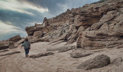 Caucasian woman walking at the beach with her chihuahua. Beautiful seascape in Los Caños de Meca,...