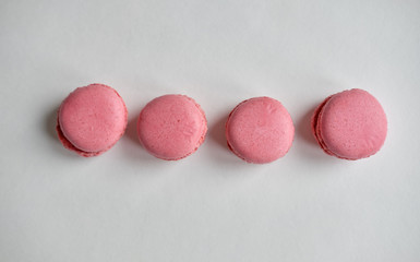 food photo pink macaroons in a row on a white background