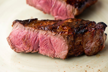 Steak. Grade A, grass fed angus beef. Traditional classic New York steakhouse menu favorite. T-bone steak, bone in, cooked to medium to rare and sliced. 