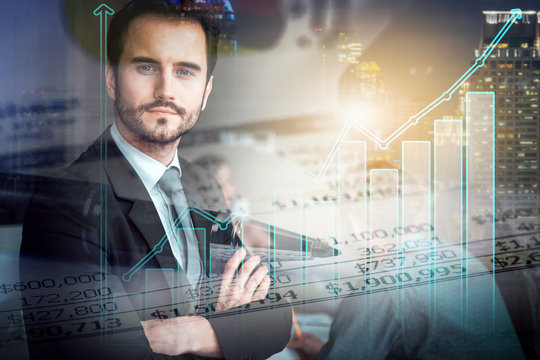 double exposure of attractive businessman and his colleagues at meeting with city night and growth statistic graph, business teamwork, investment and partnership concept.
