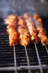 Turkish liver kebab, chicken kebab on fire with smoke