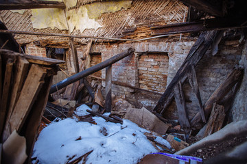 Collapsed ruined old wooden abandoned house in poor district