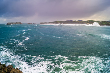 Bahia de Suances in storm day with strong waves and dramatic sky