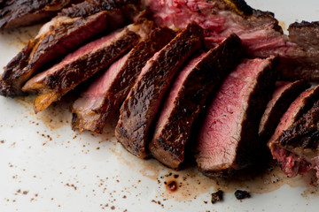 Steak. Grade A, grass fed angus beef. Traditional classic New York steakhouse menu favorite. T-bone steak, bone in, cooked to medium to rare and sliced. 