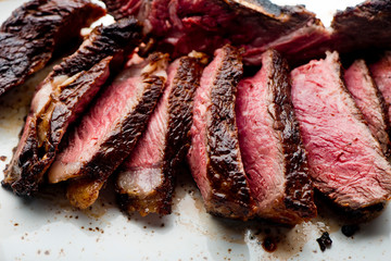 Steak. Grade A, grass fed angus beef. Traditional classic New York steakhouse menu favorite. T-bone steak, bone in, cooked to medium to rare and sliced. 