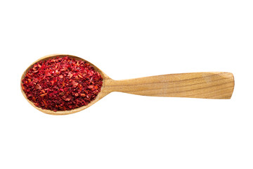 sweet pepper powder in wooden spoon isolated on white background. spice for cooking food, top view.