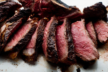 Steak. Grade A, grass fed angus beef. Traditional classic New York steakhouse menu favorite. T-bone steak, bone in, cooked to medium to rare and sliced. 
