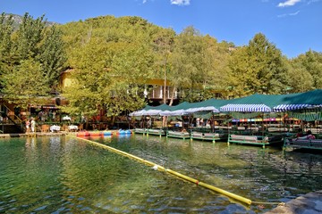 calm summer landscape on the turkish river Dim with restaurant on the water