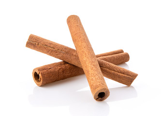  cinnamon sticks stacked on white background