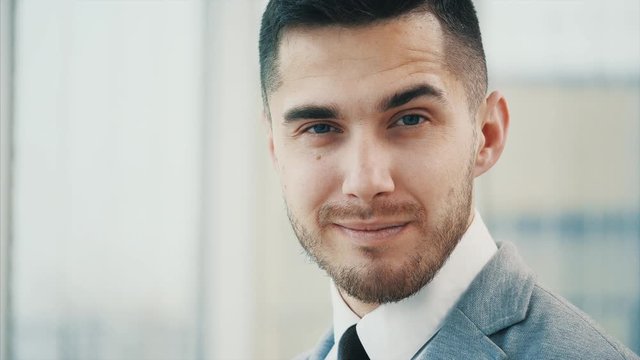 Business man giving a smirk , isolated on white panoramic background. Close up. Copy space. 4K.