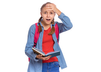 Portrait of surprised student teen girl with backpack, reading book in amazement. Shocked child with bag and open book Back to school. Girl opening eyes and mouth with shock, touching head with hand. - 327820667