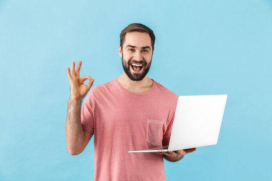 Portrait of a young cheerful bearded man wearing t-shirt