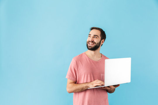 Portrait of a young cheerful bearded man wearing t-shirt