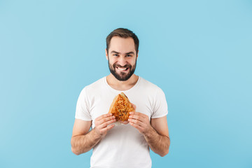 Portrait of a young cheerful bearded man wearing t-shirt