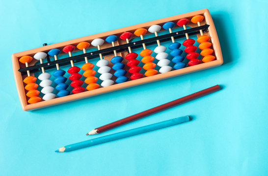 Mental arithmetic and development concept, abacus and mathematical examples on a blue background