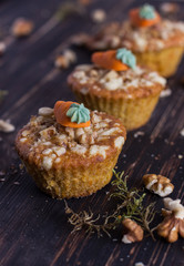 Carrot cupcakes on a wooden background