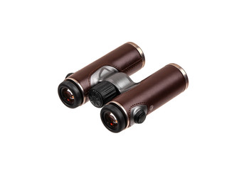 Modern luxury binoculars isolate on a white background. Silver binoculars with leather inserts. An expensive gift for a man.