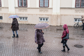 People walking in the snowfall on the street