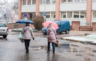 People walking in the snowfall on the street