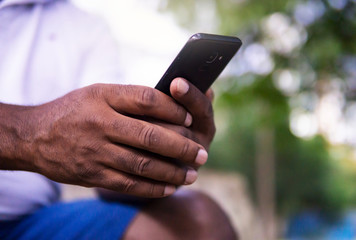 African American Hands Holding Smart Phone Device