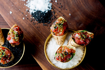 Ahi Tuna Tacos with spicy avocado sauce and wasabi dressing. Classic American restaurant appetizer. 