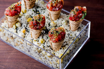 Ahi Tuna Tacos with spicy avocado sauce and wasabi dressing. Classic American restaurant appetizer. 