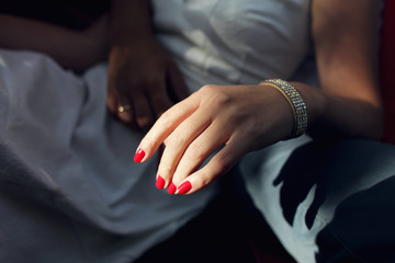 Obraz na płótnie Canvas Feminine gesture of a female hand with red nails