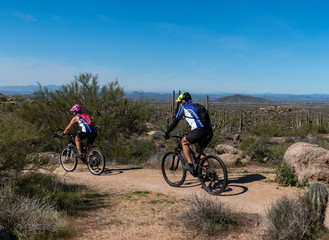 Riders On Mountain Bike Trail In Scottsdale, AZ