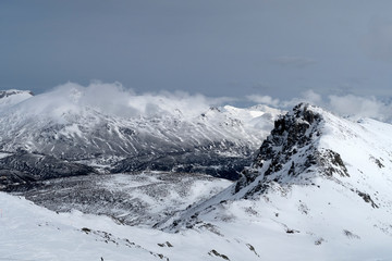 Fototapeta na wymiar Snowy mountains. Winter. Cloudscape.