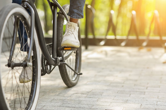 cropped shot of businessman in classic shoes riding vintage bicycle