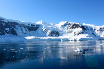 Fototapeta na wymiar Mountains and icebergs between the islands around the Antarctic Peninsula, Palmer Archipelago, Antarctica