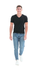 Fototapeta premium in full growth. confident guy striding towards his goal