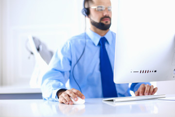 Businessman in the office on the phone with headset, Skype, FaceTime