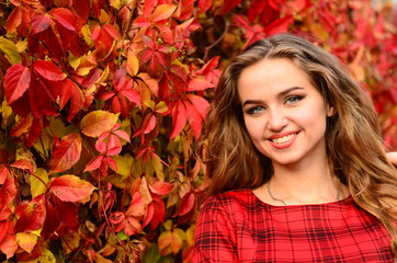 Outdoor fashion photo of young beautiful lady surrounded autumn leaves