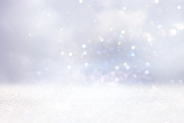 glitter vintage lights background. gold, silver and white. de-focused