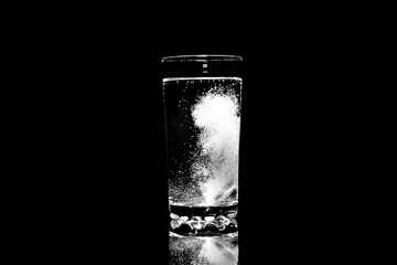 Aspirin dissolves in a glass of water.