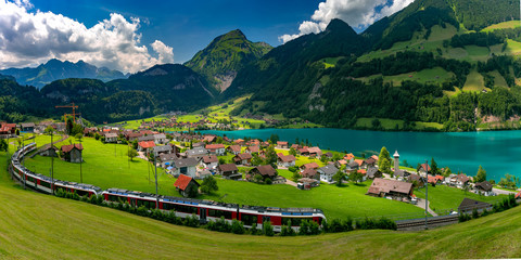 Famous electric red tourist panoramic train in swiss village Lungern, canton of Obwalden, Switzerland