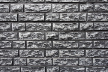 Texture of gray and black brick veneer wall