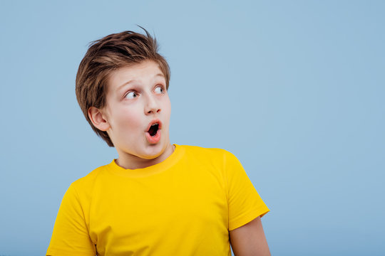 Scared Boy Look Aneway In Yellow T-shirt Isolated On Yellow Background, Copy Space,